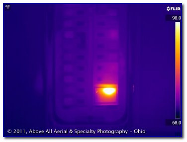 infrared image showing a warm, whole-house surge supressor in an electric panel