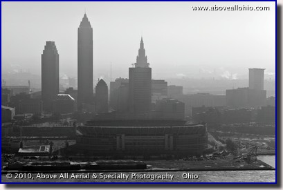 A low level aerial view of Cleveland Browns Stadium and downtown Cleveland on a hazy winter day.