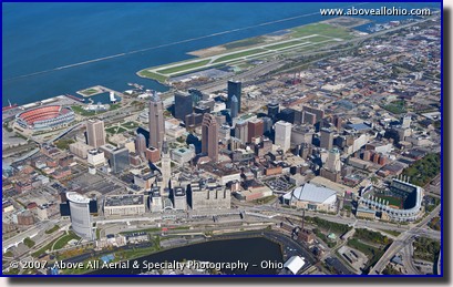 A wide angle oblique aerial view of downtown Cleveland, Ohio, Burke Lakefront Airport, and Lake Erie
