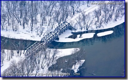 Aerial photo of a snowy train tressel bridge over a river in Pennsylvania