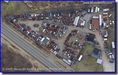 Aerial photo of a junk (salvage) yard with several vintage cars and trucks