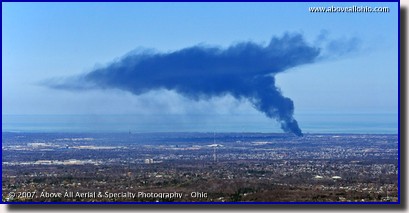 Aerial photo of smoke rising and dispersing from a large fire west of Cleveland, OH