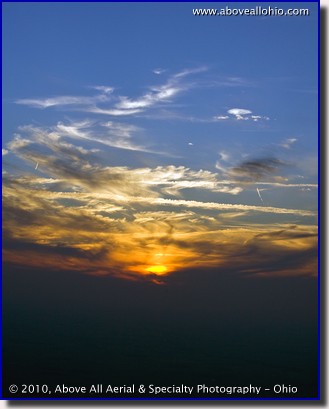 Aerial photograph of clouds and jet contrails at sunset over Indiana