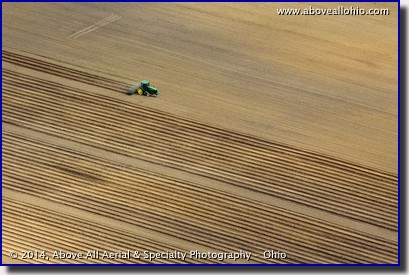 An aerial view of a farmer preparing a field for planting; near Greenwich, Ohio.